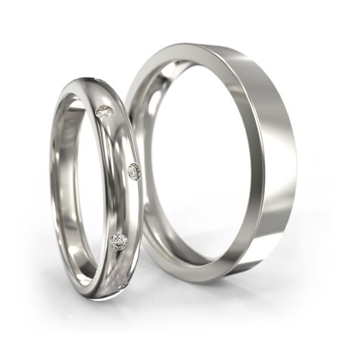 Классические обручальные кольца из белого золота с бриллиантами в женском кольце